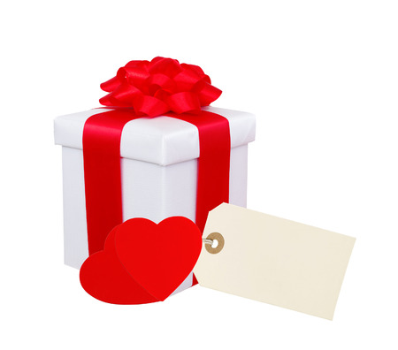 Gift box with red ribbon, hearts and tag (label) isolated on white の写真素材