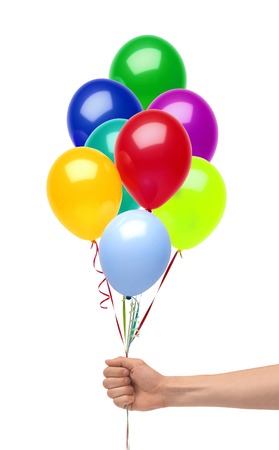 Hand holds colorful balloons isolated on white の写真素材