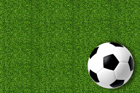 football on fresh spring green grassの写真素材