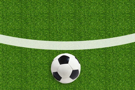Soccer ball on green field grassの写真素材