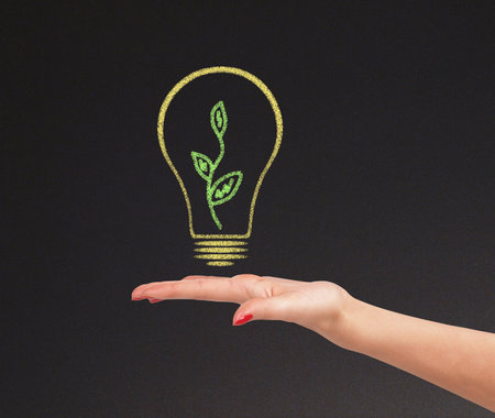 hand hold bright light bulb with chalk boardの写真素材