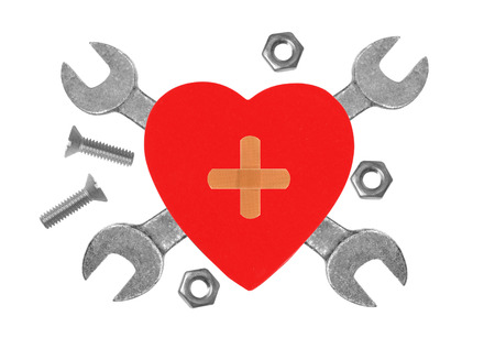 Heart and tools. Concept: Renovation of heart. Isolated on whiteの写真素材