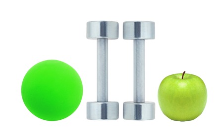 Chromed fitness dumbbells, ball and green apple isolated on white backgroundの写真素材