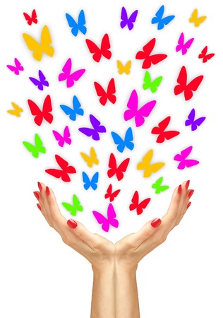 Paper colorfull butterflies fly from woman hands over white の写真素材