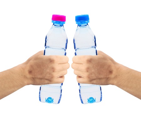 Human hands holding bottles of water isolated on whiteの写真素材