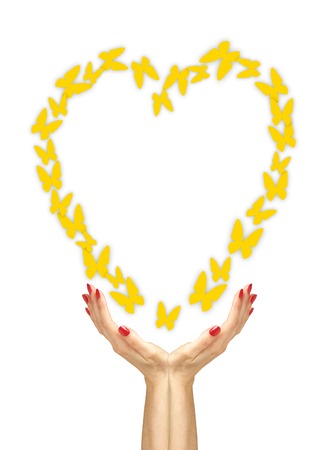 Paper yellow butterflies fly from woman hands over white backgroundの写真素材