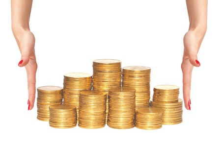 golden coins and woman hands isolated on whiteの写真素材