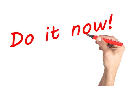 Hand writing Do it now on transparent boardの写真素材