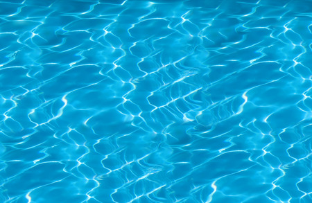 beautiful clear pool water reflecting in the sun backgroundの写真素材