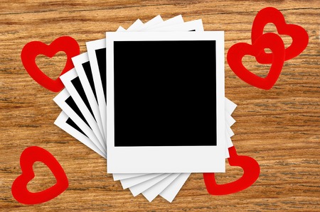 Film Vintage empty photo cards and red hearts on wood backgroundの写真素材
