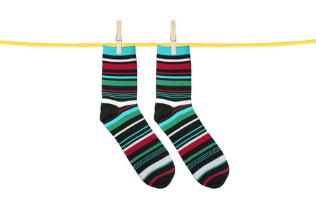 Striped socks hanging isolated on whiteの写真素材