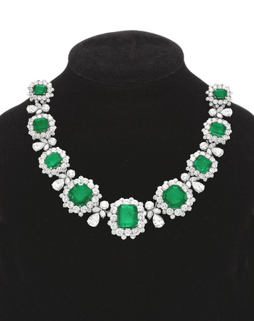 Pendant with green gem stones on black mannequin isolated on whiteの写真素材
