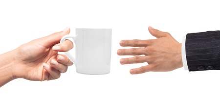 Woman hand with cup of coffee and man hand isolated on whiteの写真素材