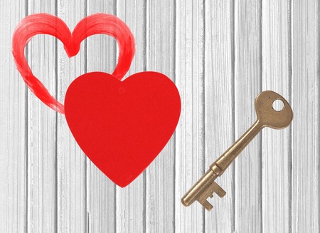 red heart and key white wooden backgroundの写真素材