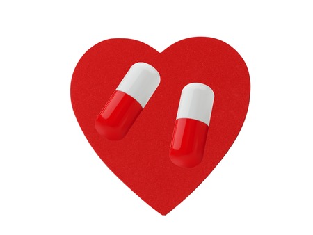 Heart and pills isolated on white backgroundの写真素材