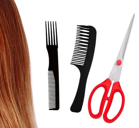Red scissors, combs and brown hair isolated on white backgroundの写真素材