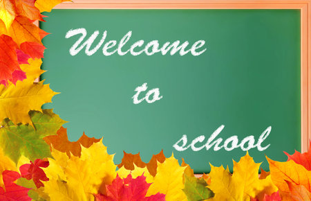School blackboard with words welcome to school and maple leaves