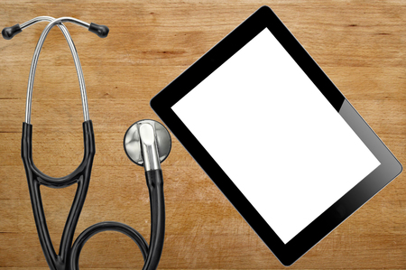 Stethoscope and digital tablet on wooden backgroundの写真素材