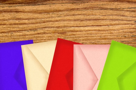 Color letters envelopes on wooden texture close-upの写真素材