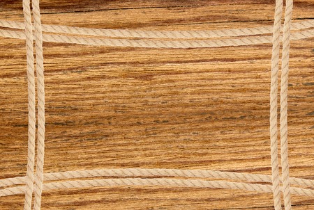 Frame composed of rope over wooden backgroundの写真素材