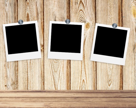 Blank old photos on clips on wooden backgroundの写真素材