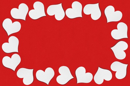 Frame of white paper hearts on red backgroundの写真素材