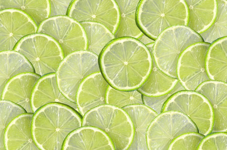 Green background with citrus-fruit of lime slices