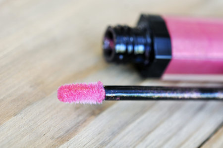 Pink lipgloss on wood tableの写真素材