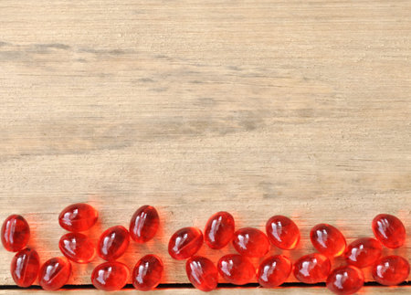 Red Pills (Drugs) On Wood Table Backgroundの写真素材