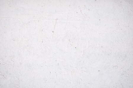 Background With White Plaster Wall With Uneven Surfaceの写真素材