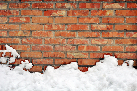 White snow on red brick wallの写真素材