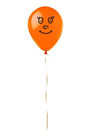 Orange flying balloon with smile face isolated on white backgroundの写真素材