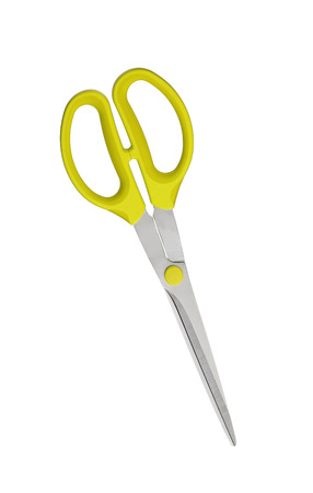 Yellow scissors on fabric isolated on white backgroundの写真素材