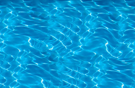 beautiful clear pool water reflecting in the sun backgroundの写真素材