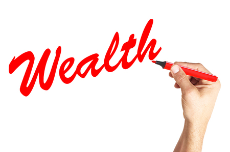 Hand writing word Wealth on white boardの写真素材
