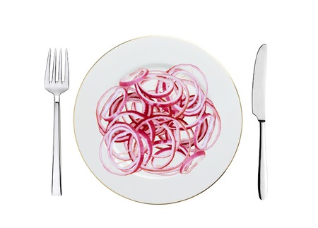 slices of red onion on white plate, spoon and fork isolated on whiteの写真素材