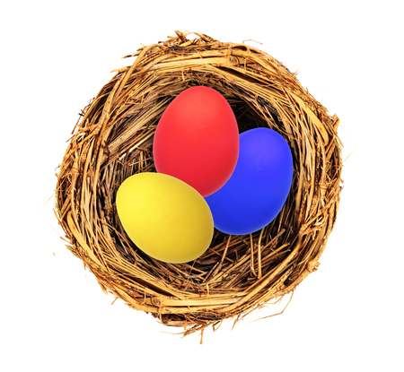 Easter eggs in nest isolated on white backgroundの写真素材