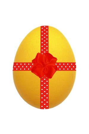 Yellow Easter egg with red ribbon and bow isolated on whiteの写真素材