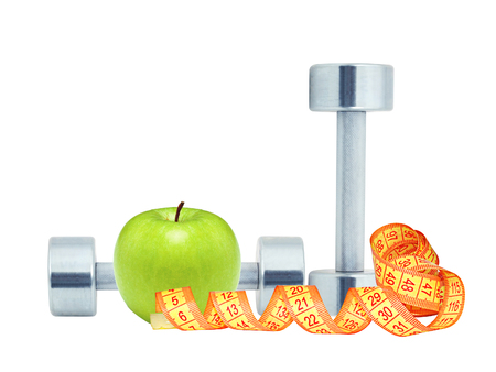 Chromed fitness dumbbells, measure tape and green apple isolated on white backgroundの写真素材