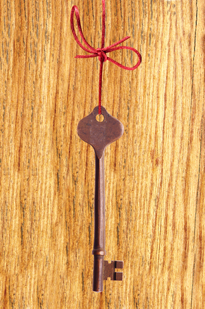 Old key on a wooden backgroundの写真素材