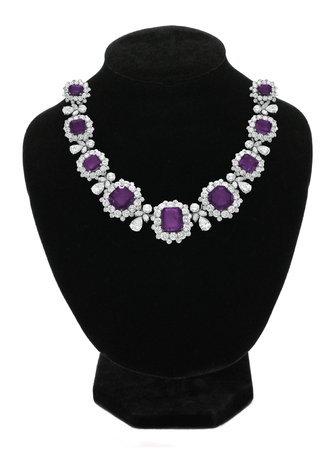 Pendant with purple gem stones on black mannequin isolated on whiteの写真素材