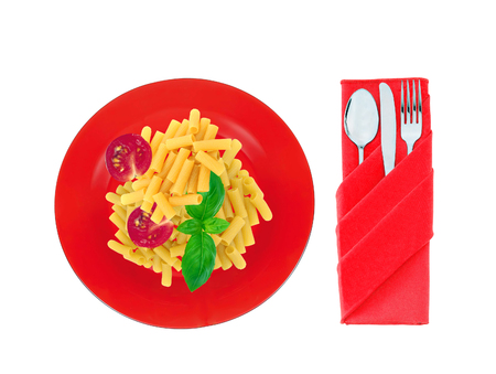Delicious pasta with tomato and basil on red plate isolated on whiteの写真素材