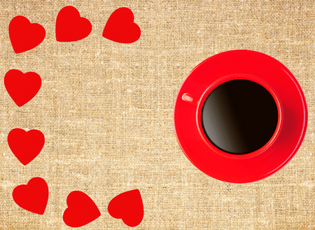 Border frame of red hearts and coffee cup on sack canvas burlap background textureの写真素材