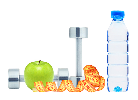 Chromed fitness dumbbells, measure tape and green apple isolated on white backgroundの写真素材