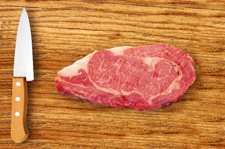 knife and meat on cutting board isolated on white backgroundの写真素材