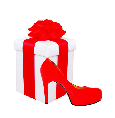 present box with red bow and woman shoe isolated on white backgroundの写真素材