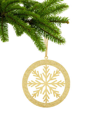Golden Glitter Decorative Ball with Snowflake on Green Christmas Fir Tree isolated on White Backgroundの写真素材