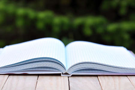 book with white empty pages on the table outdoor in the gardenの写真素材