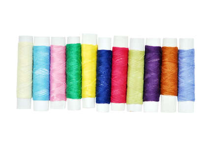 Many colorful thread bobbins isolated on white for hand made concept designの写真素材