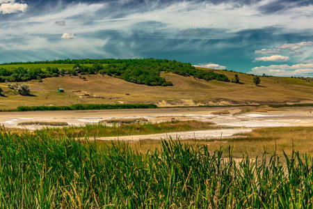 Typical landscape in the plains of Transylvania, Romania. Green landscape in the midsummer, in a sunny dayの写真素材